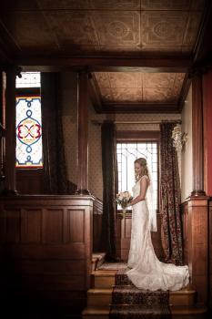bride standing at foot of staircase