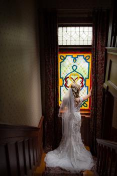 bride standing on landing of staircase