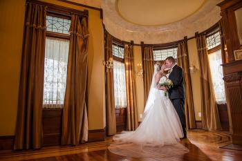 bride and groom standing in room inside the mansion
