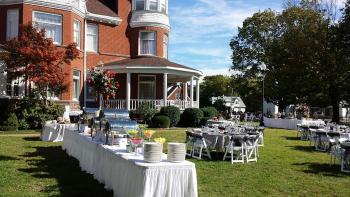 exterior view of mansion with tables setup for wedding